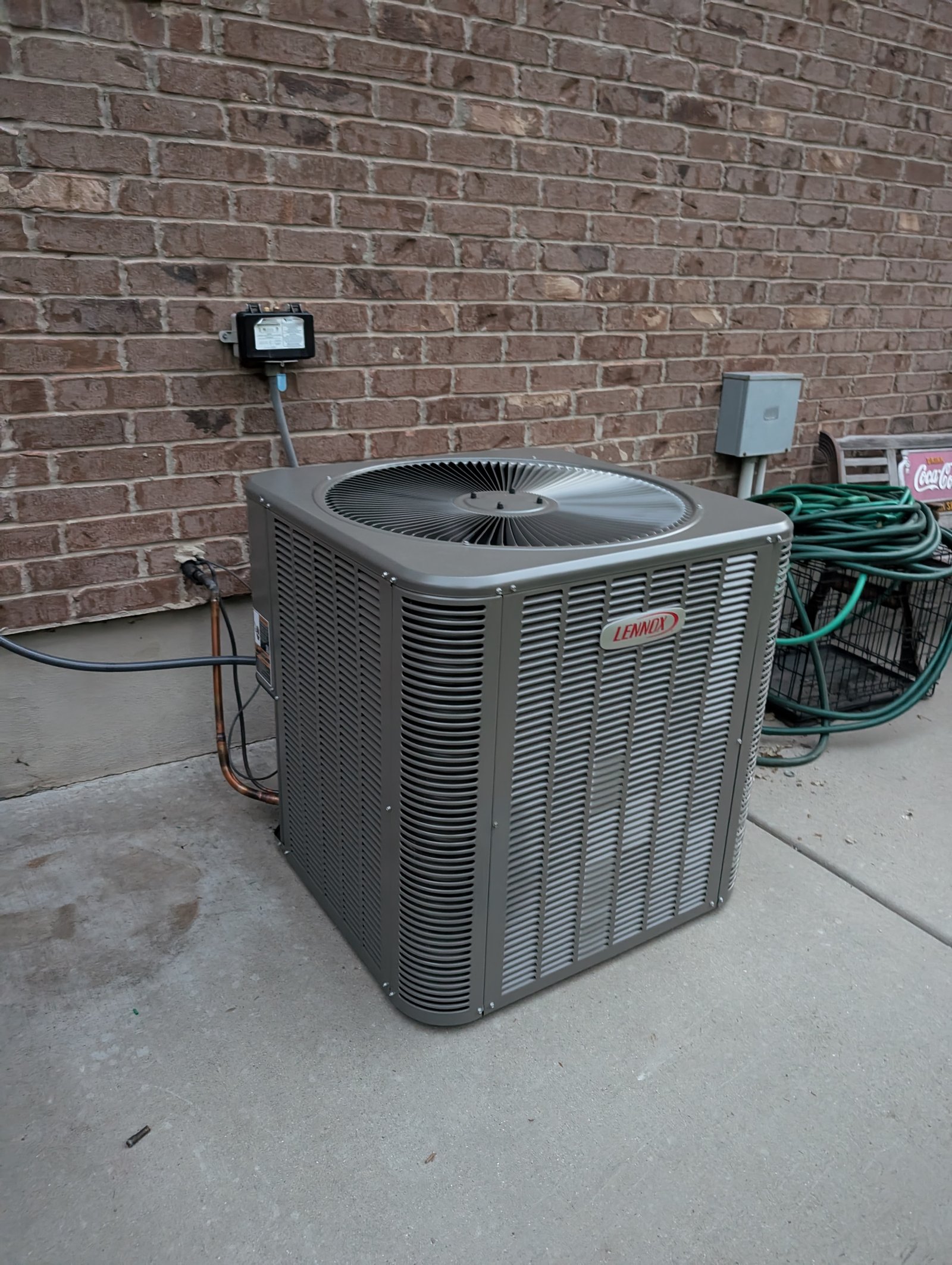 AC Repair Lehi - AC Unit by brick wall